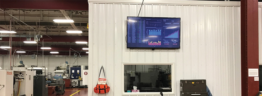 tv on wall displaying dashboard of weekly production rates and job status