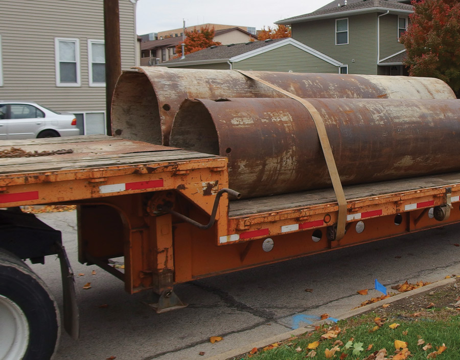 flatbed trailer has been loaded with large-diameter pipe