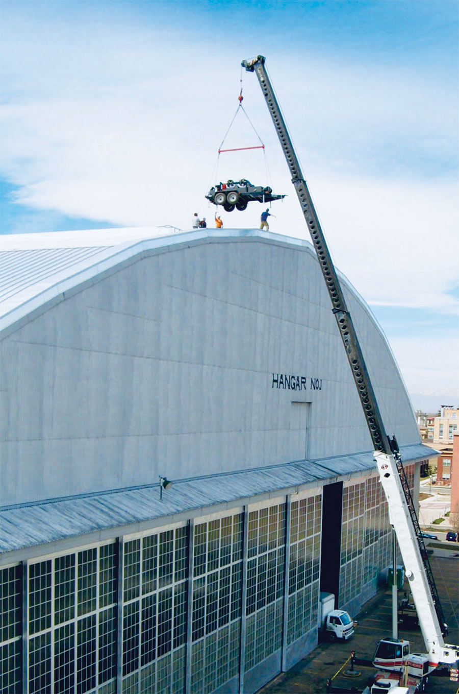 metal roofing being installed with the help of a crane