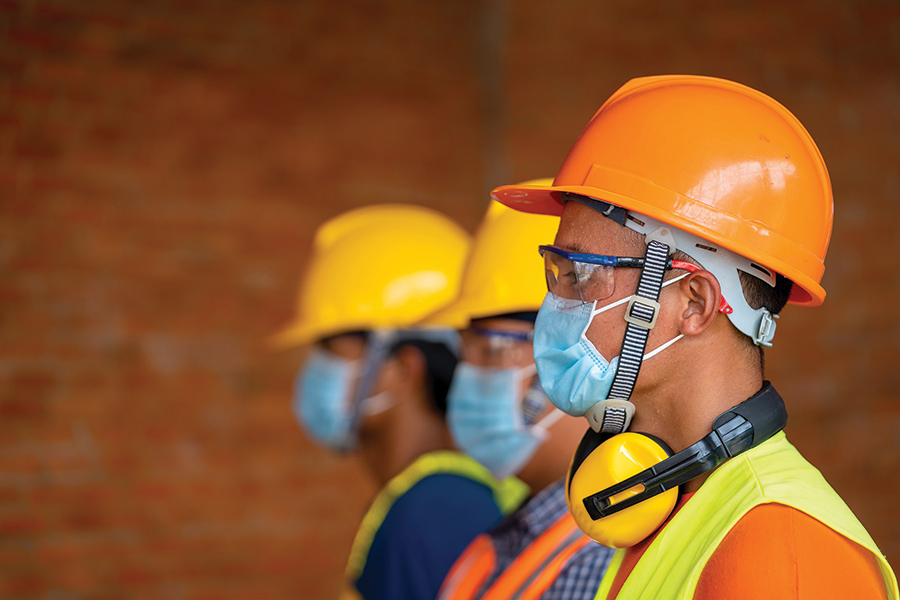 ASTM International workers wearing safety vests and helmets